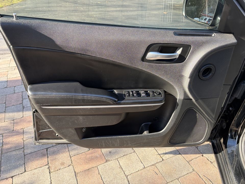 Black interior door panel with chrome handle and window controls