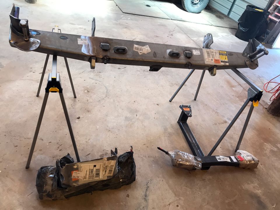 Vehicle bumper assembly and hitch receiver parts on sawhorses