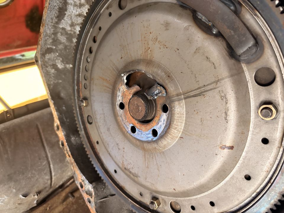 Damaged flywheel with broken teeth and part of the transmission bell housing