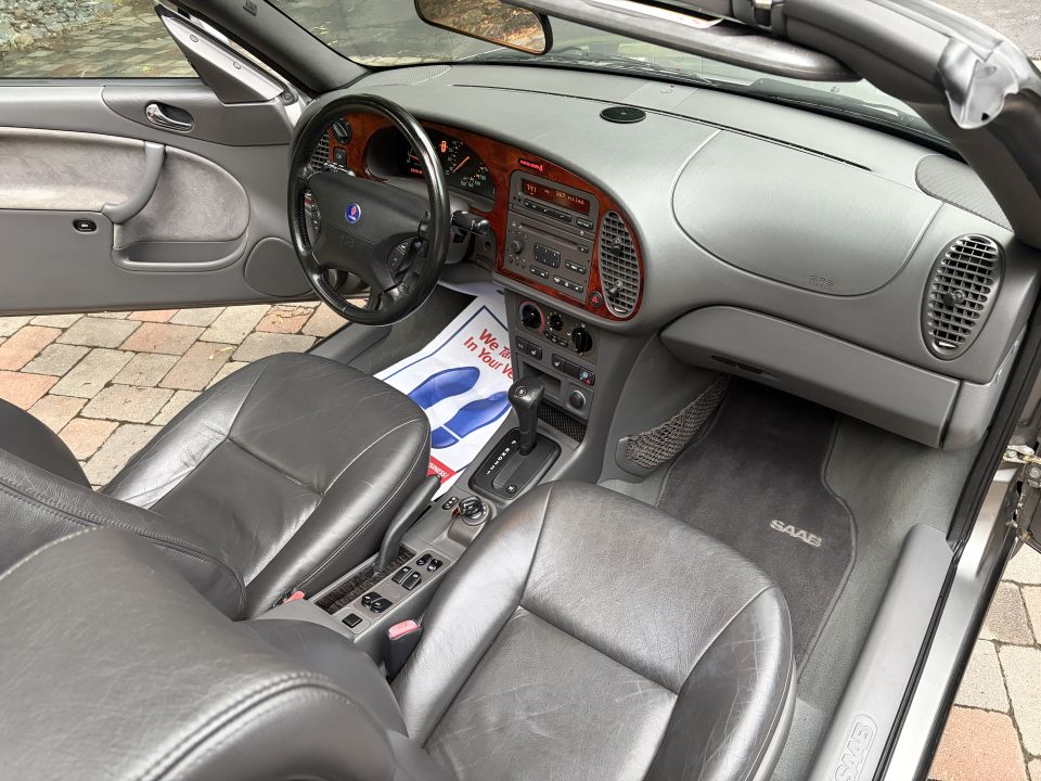 Saab convertible interior with gray leather seats, top down