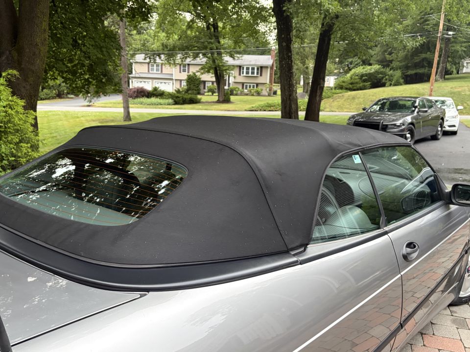 Raised black convertible soft top with heated glass rear window
