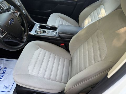 2001 Ford Crown Victoria - Interior of a Ford sedan showing the light stone cloth front seats, center console with rotary gear selector, and the leather steering whee…