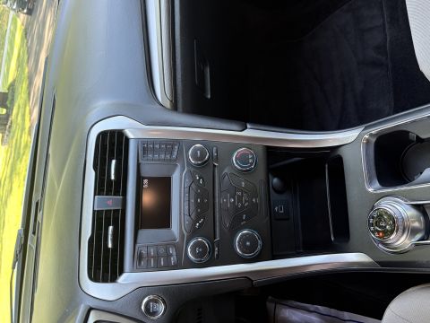 2001 Ford Crown Victoria - Center console and dashboard of a Ford, photographed sideways, showing the climate controls, radio display reading 5:35, push-button start,…