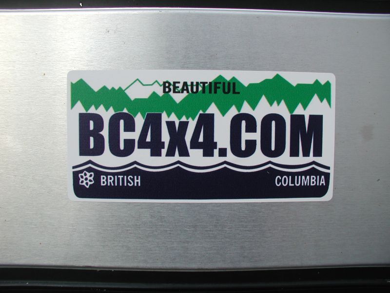 Sticker with text "BEAUTIFUL BC4X4.COM BRITISH COLUMBIA" on a metallic surface.