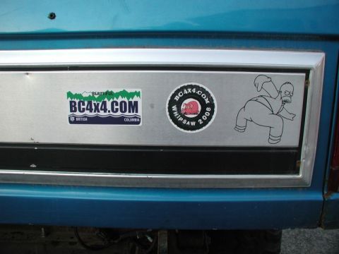 1985 Ford Bronco - This image shows the rear panel of a blue vehicle, likely a 1985 Ford Bronco, featuring two stickers. One sticker reads "BEAUTIFUL BC4X4.CO…