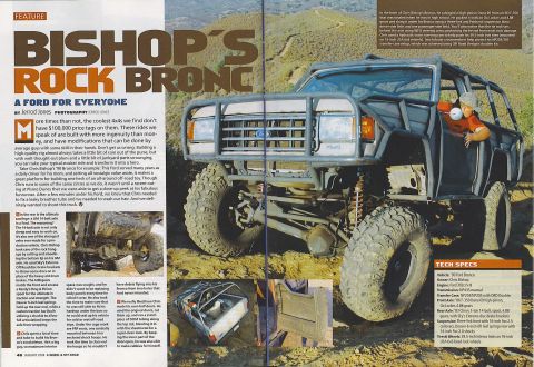 1985 Ford Bronco - A heavily modified 1990 Ford Bronco is shown in a three-quarter front view, parked on a dirt trail with large off-road tires. The vehicle f…