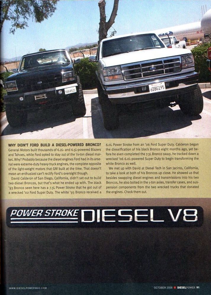 Black and white Ford Broncos parked side-by-side, both modified with diesel engines.