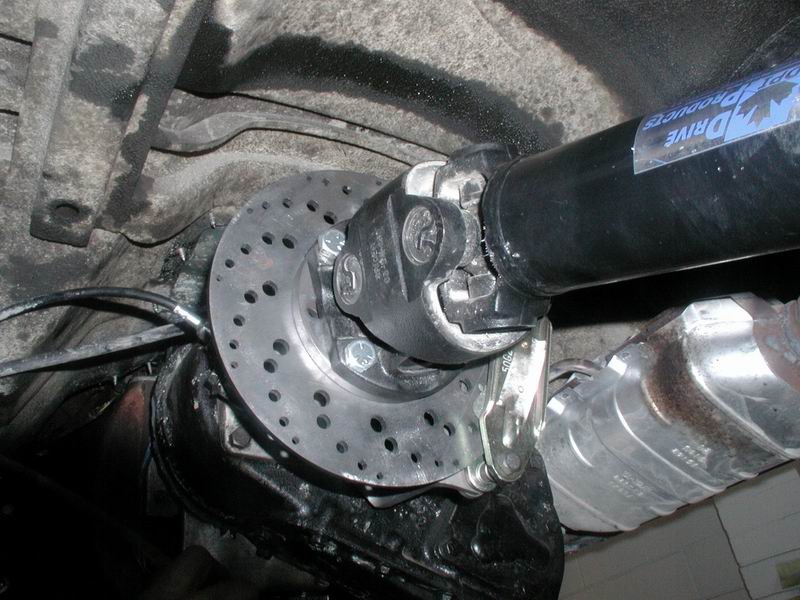 Custom brake rotor and driveshaft on a vehicle's rear axle.