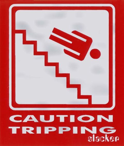 1985 Ford Bronco - A red and white caution sign depicts a stylized person falling down stairs. Text below reads "CAUTION TRIPPING slacker".
