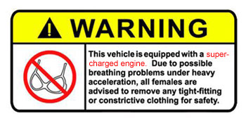 1985 Ford Bronco - A yellow warning sticker with black text and a red circle with a line through a bra is shown. The text reads "WARNING" and "This vehicle is…