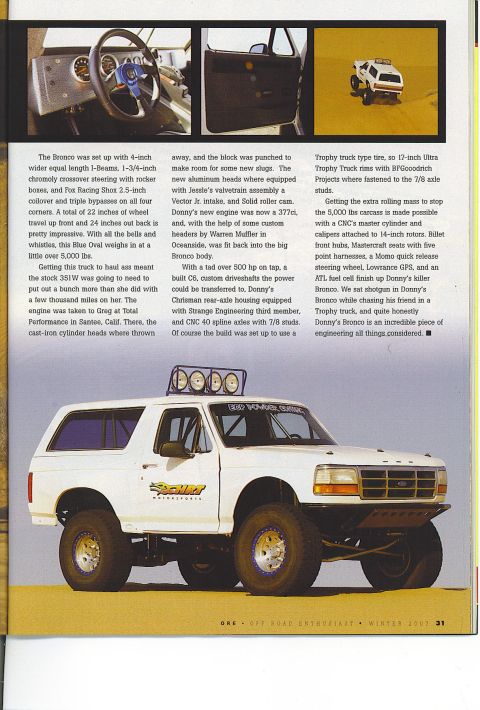 1985 Ford Bronco - A white Ford Bronco is shown in a desert scene with large off-road tires and custom suspension. The vehicle has racing decals on the door a…
