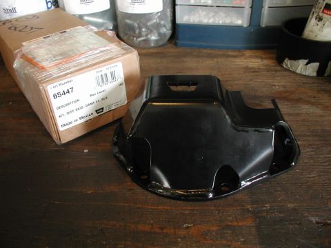 1985 Ford Bronco - A black differential skid plate sits next to its cardboard packaging, which is labeled with part number 65447 and the description "KIT, DIF…