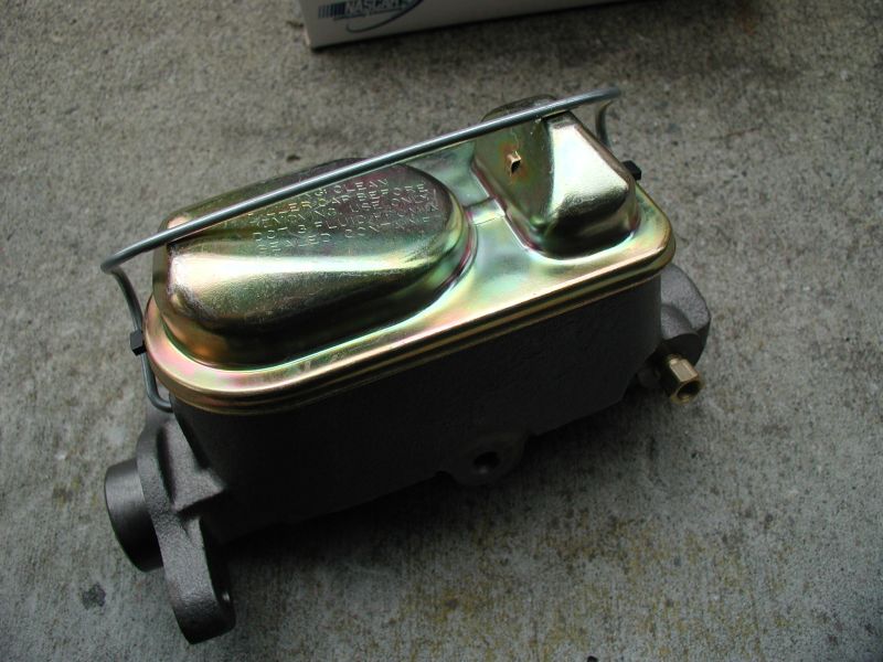 New dark gray master cylinder with gold lid on concrete