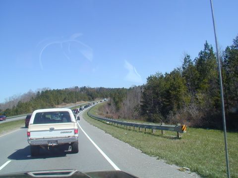 1988 Ford Bronco - Traffic jam on a highway with a white Chevrolet pickup truck in the foreground.