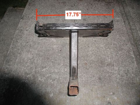1985 Ford Bronco - A metal grill part with a measurement of 17.75 inches is shown resting on a concrete surface.