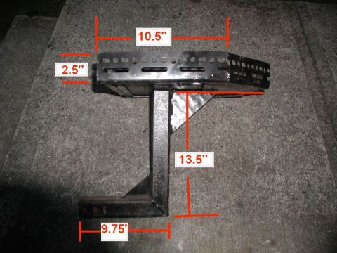 1985 Ford Bronco - This is a close-up shot of a custom metal hitch-mounted cargo carrier with various dimensions marked. The carrier is black and appears to b…
