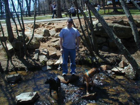 1988 Ford Bronco - Man and his dogs enjoy a day by the stream in a wooded area.