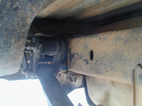 1988 Ford Bronco - Close-up of vehicle undercarriage showing frame and suspension parts, likely from an older truck or SUV.