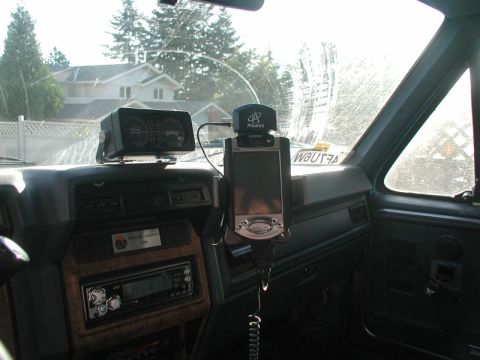 1985 Ford Bronco - The interior of a vehicle's dashboard featuring a GPS unit mounted above a JVC car stereo. A gauge cluster is visible on the left side of t…