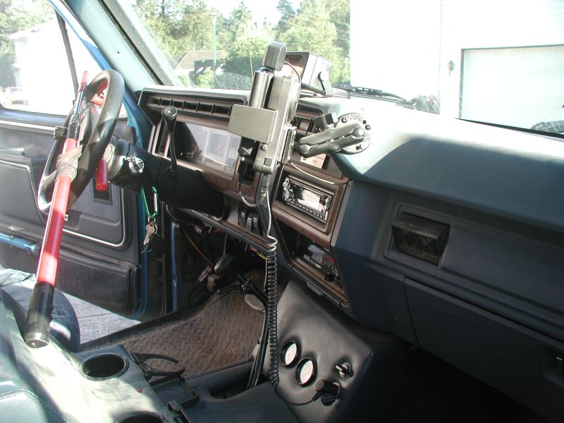 Interior of a blue Ford Bronco showing dashboard, steering wheel, and center console.
