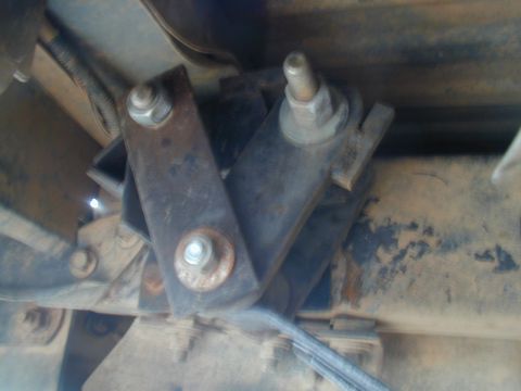 1988 Ford Bronco - A close-up view of a vehicle's suspension bracket, showing signs of rust and wear.