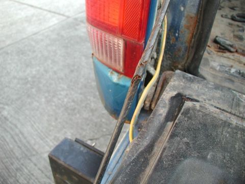 1985 Ford Bronco - The left one is hanging on by a few strands.