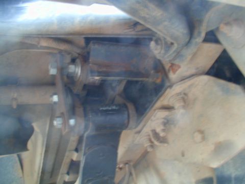 1988 Ford Bronco - Underside view of a vehicle's suspension system, showing various metal components and fasteners.