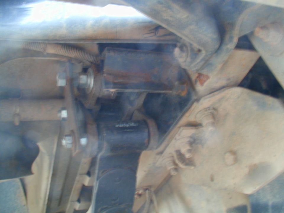 close-up of vehicle's rear suspension with visible bolts and brackets