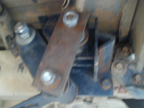 1988 Ford Bronco - Detail of vehicle suspension hardware, showing rust and bolted connections.