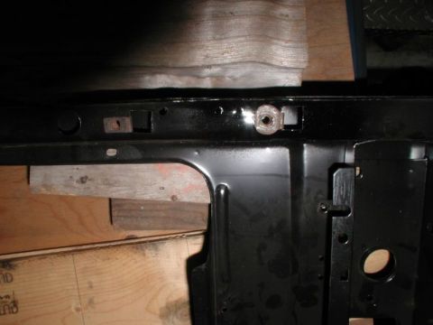 1985 Ford Bronco - The right radiator mount nut after making the holes.