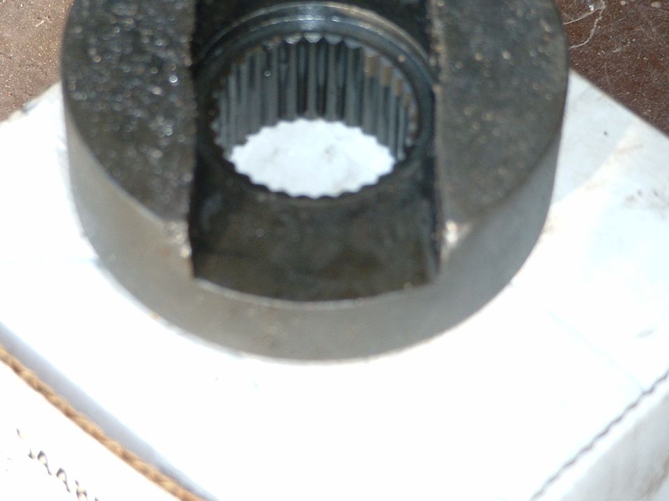 Close-up of black steel mini-spool locker showing internal axle splines