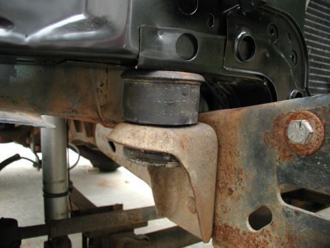 1985 Ford Bronco - Rad support mounts in place. I had to trim down the shoulder a lot, as the factory hole was narrow and almost oval shaped.