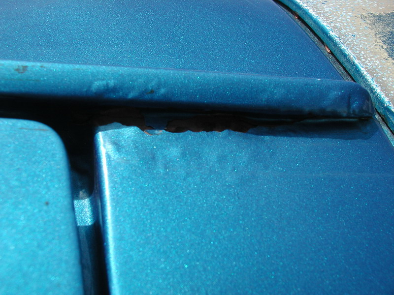 Drivers side, rear of rain gutter.