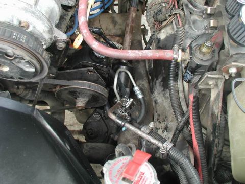 1985 Ford Bronco - Return line going to cooler in front of grille.