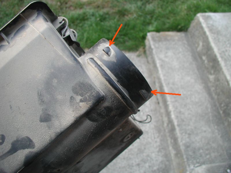 First I removed the airbox. Then I ground off the three short tabs that the factory hose "locked" onto.