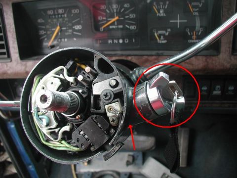 1985 Ford Bronco - Turn the ignition cylinder to "on", press in the retaining pin and pull out the cylinder.