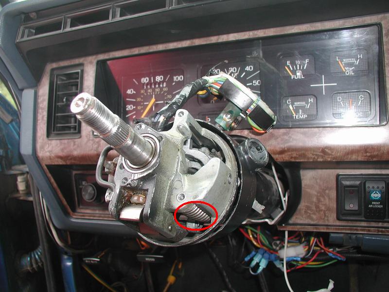 Carefully put the tilt spring in.