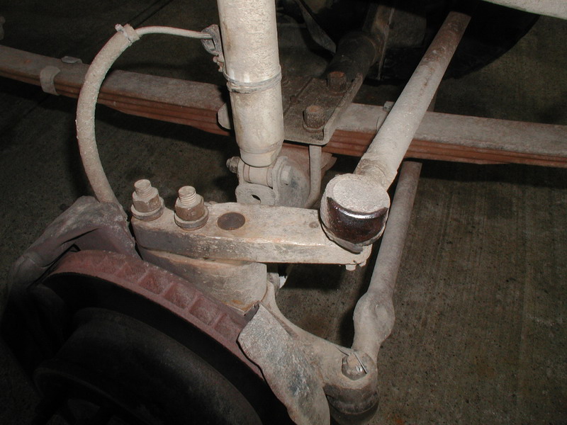 Vehicle suspension and brake components including rotor, shock, leaf springs, and tie rod.
