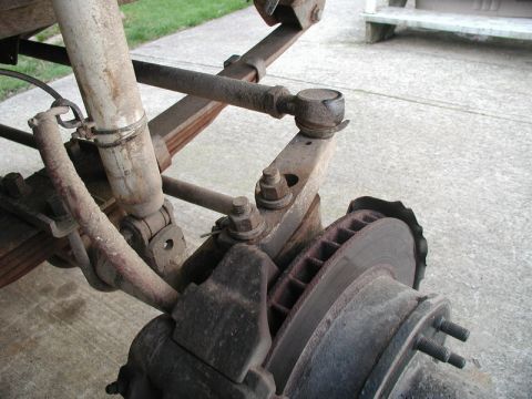 1985 Ford Bronco - This is a close-up view of the suspension and braking system of a vehicle, likely a truck or SUV. Visible components include a shock absorb…