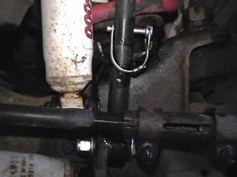 1985 Ford Bronco - This is a close-up view of the steering linkage and a shock absorber on a 1985 Ford Bronco. The shock absorber is white with red lettering,…