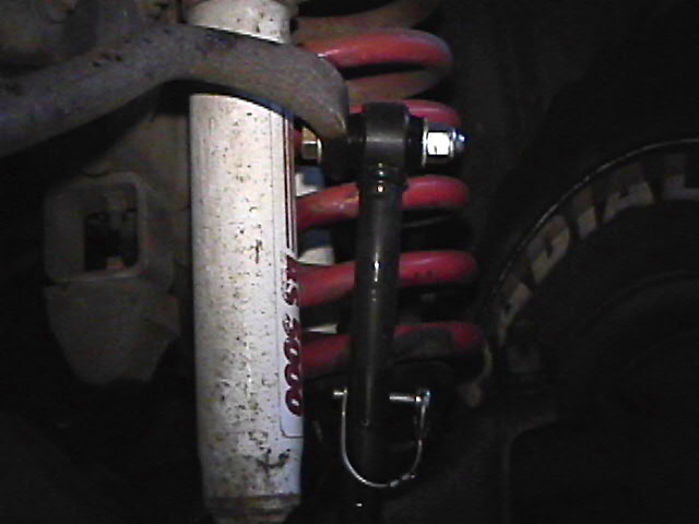 Vehicle suspension with shock absorber, coil spring, and sway bar end link.