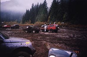 1985 Ford Bronco - Here is Greg Sue winching Rob Holzmann after he got stuck. Note the 'Zuk in the foreground that accidentally sprayed Greg, Rob and the inte…