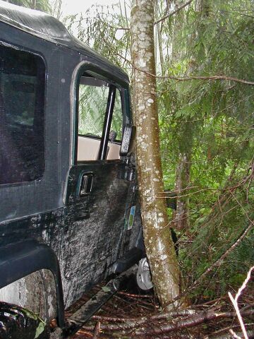 1985 Ford Bronco - John slid off to the right while crossing the fallen tree. He had about 1/4" of clearance at this point.