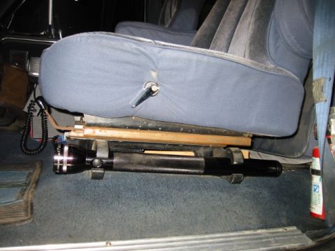 1985 Ford Bronco - Close-up view of the interior of a vehicle, focusing on the seat and floor area.