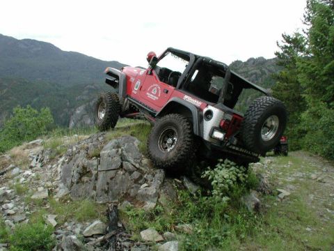 1985 Ford Bronco - Yasu climbs up onto a rock ledge overlooking the lake.