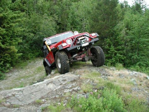 1985 Ford Bronco - Yasu climbs up onto a rock ledge overlooking the lake.
