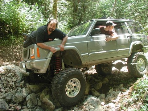 1985 Ford Bronco - He was on three wheels and couldn't go forward or backwards.Doug stabilized the situation while I backed down and gave him the strap.