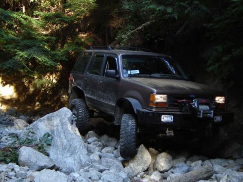 Dark brown SUV with winch on rocky trail