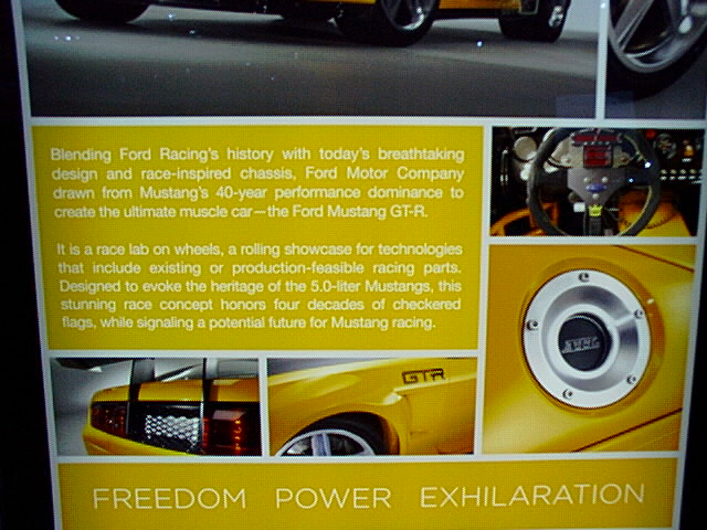 Yellow Ford Mustang GT-R concept display board with detail photos and heritage text