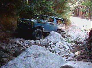 1985 Ford Bronco navigating a rocky trail